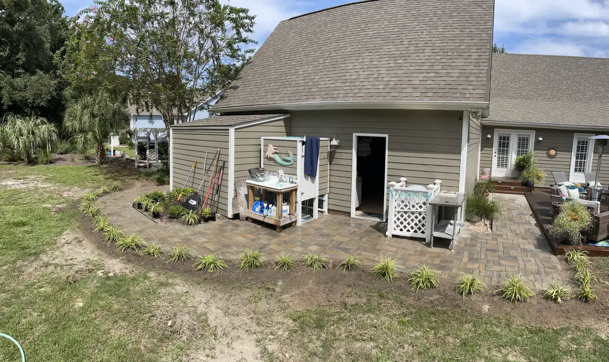 Freshly installed sod lawn with landscape beds in Wilmington NC property