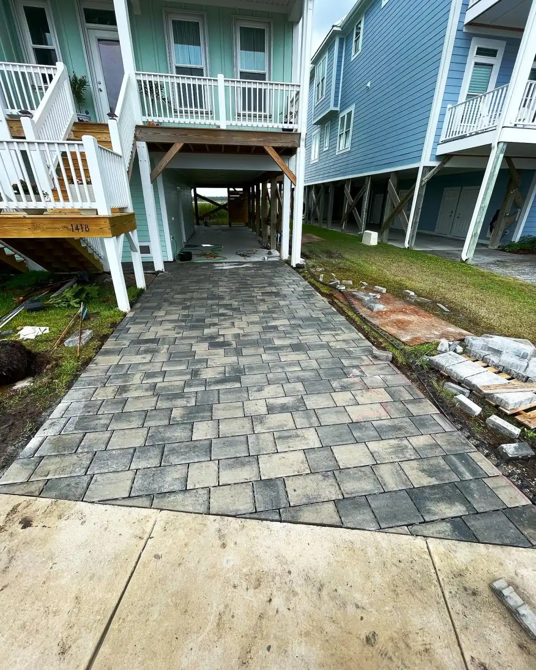 Custom stone fire pit with Adirondack seating on paver patio in Wilmington NC
