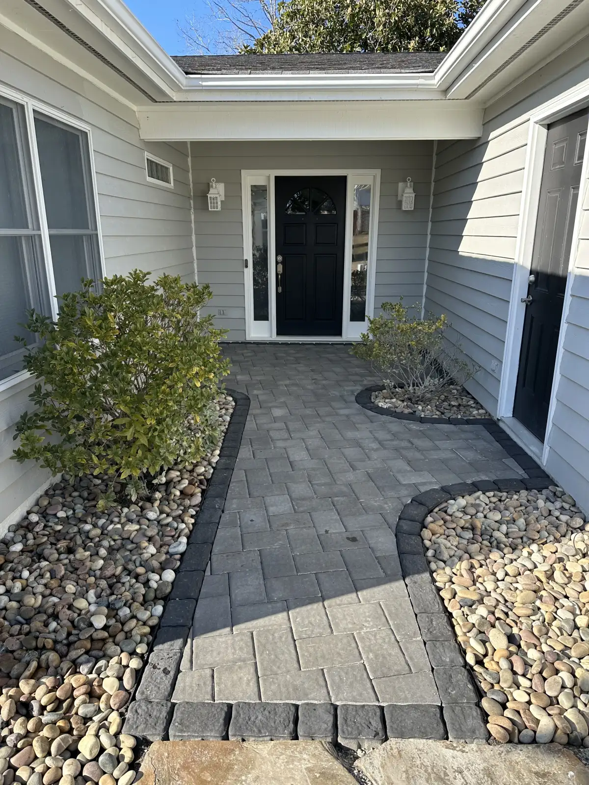 Segmental retaining wall with integrated paver patio in coastal NC luxury home